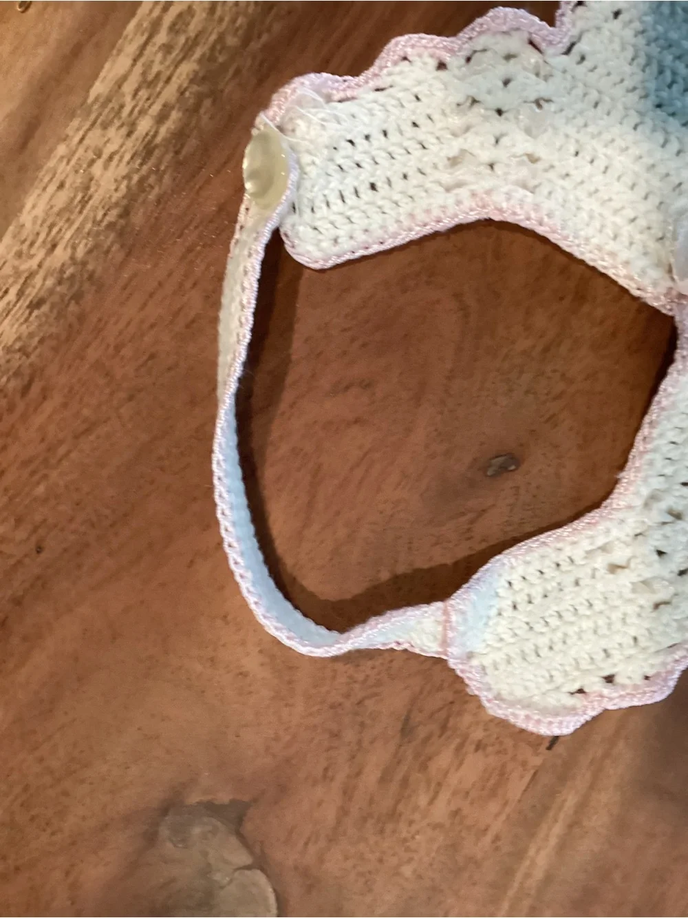 Vintage hand-made crocheted baby bib with pink scalloped lace look trim. 1950s